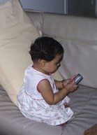Keya playing with the handphone